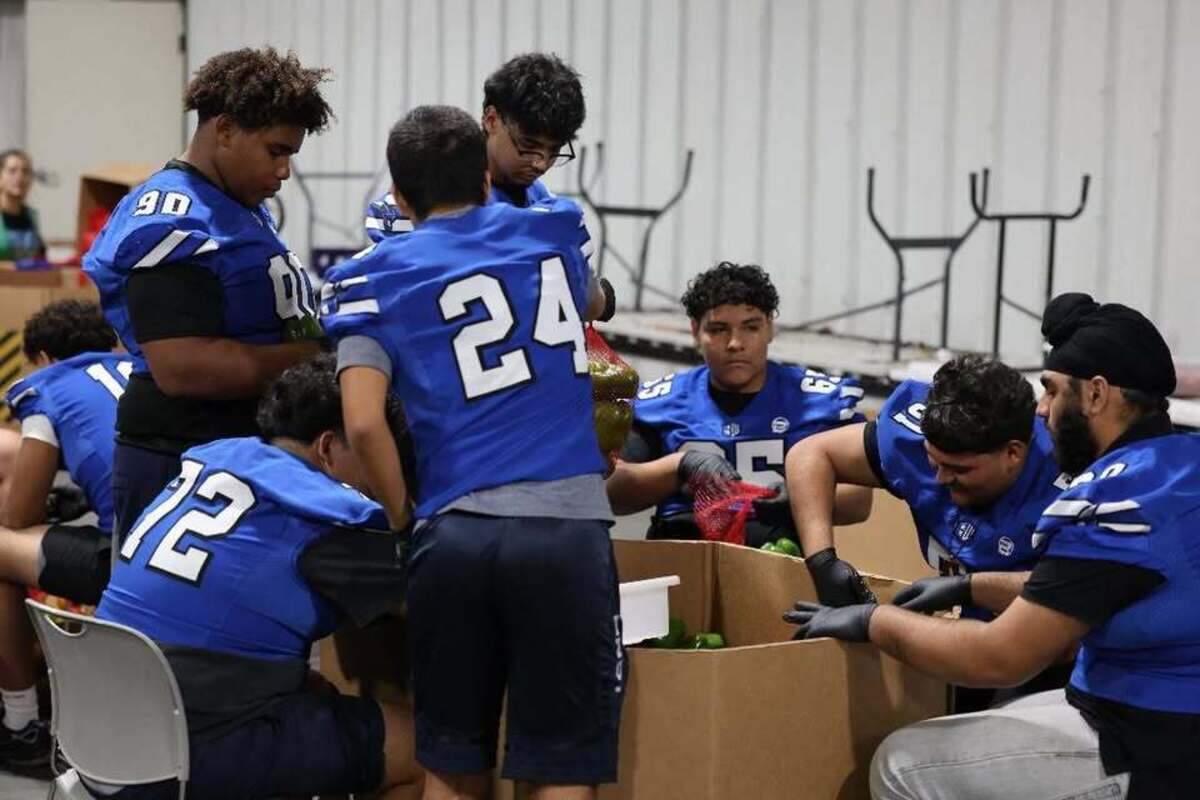 The Sanger West football players volunteer to pack bell peppers at the Central California Food Bank.